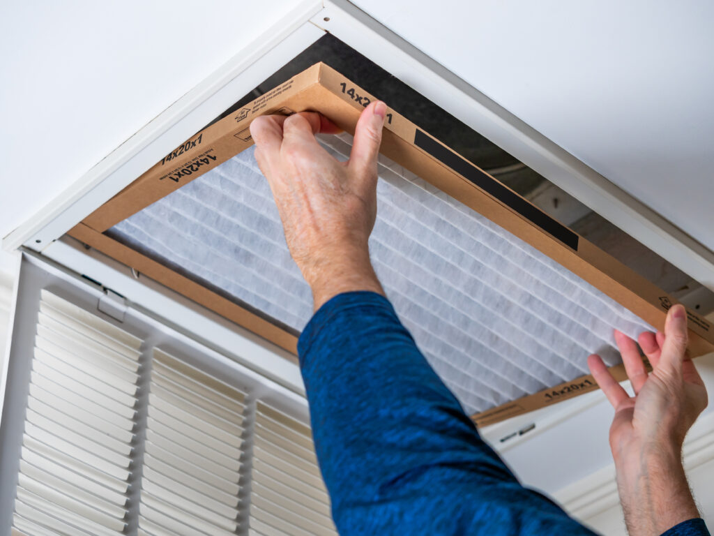 HVAC technician replacing a home air filter in Rocklin