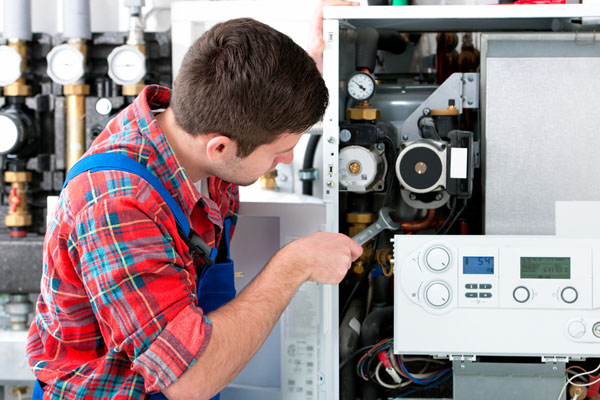 Heating technician repairing boiler controls in Rocklin