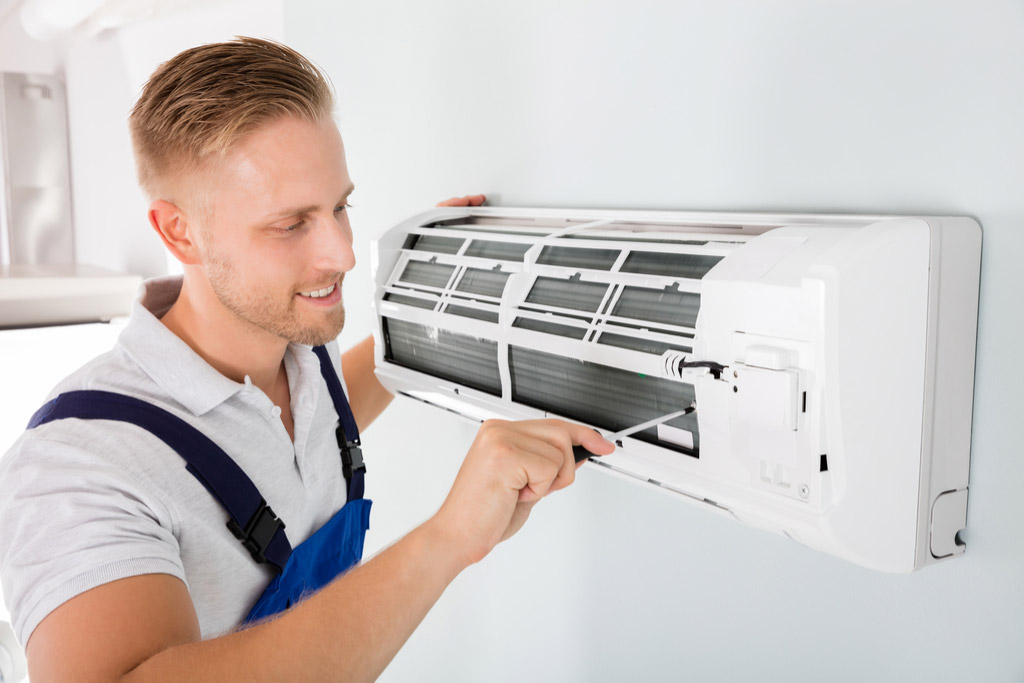 HVAC technician maintaining a ductless air conditioner in Rocklin