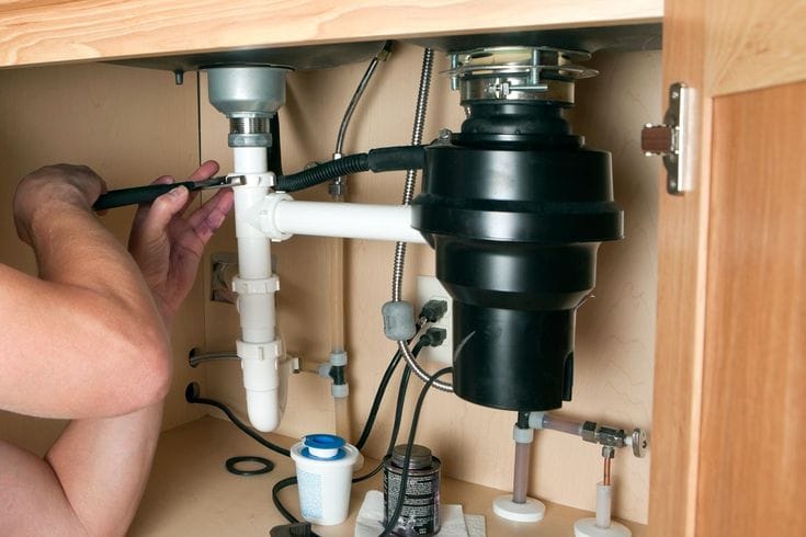 Plumber repairing a garbage disposal in Rocklin