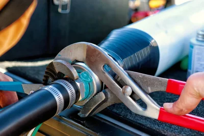 Technician repairing an industrial pipe connection in Rocklin