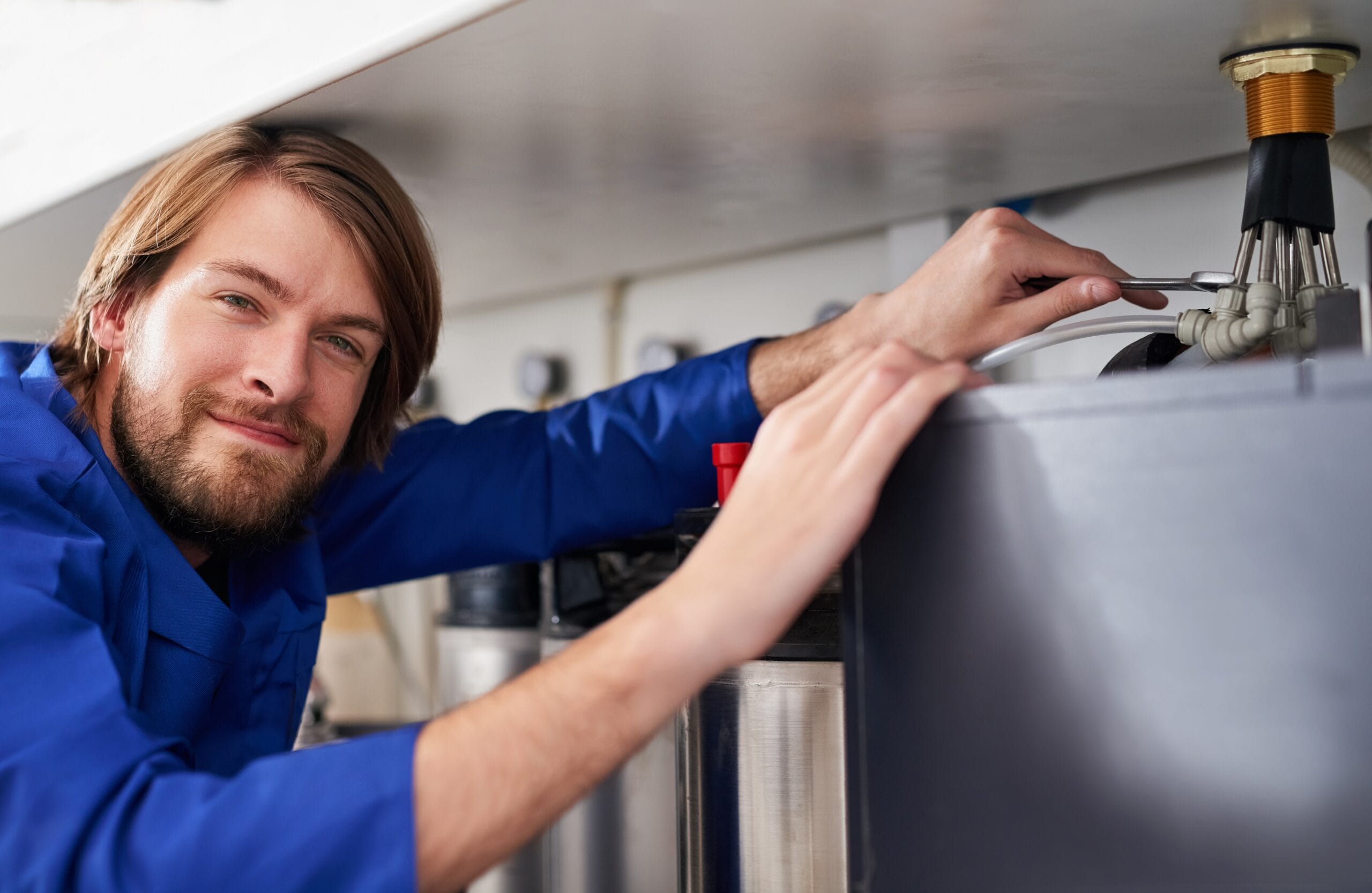 Technician servicing a residential water heater tank in Rocklin